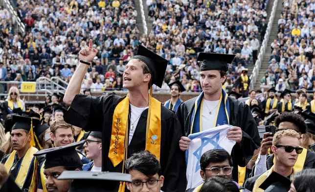 Graduates sporting Israeli flags and pins shout at Pro-Palestinian protesters as they demonstrate during the University of Michigan's Spring 2024 Commencement Ceremony at Michigan Stadium in Ann Arbor, Mich., on Saturday, May 4, 2024.( Jacob Hamilton/Ann Arbor News via AP)