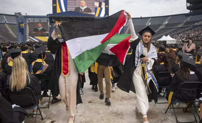 Pro-Palestinian protesters demonstrate during the University of Michigan's Spring 2024 Commencement Ceremony at Michigan Stadium in Ann Arbor, Mich., on Saturday, May 4, 2024. (Katy Kildee/Detroit News via AP)