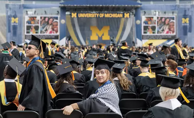 A graduate waits for the University of Michigan's Spring 2024 Commencement Ceremony to begin at Michigan Stadium in Ann Arbor on Saturday, May 4, 2024. (Jacob Hamilton/Ann Arbor News via AP)