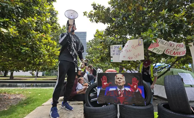 FILE - A man uses a megaphone to chant against the Israel-Hamas war at a protest site set up at the University of Texas at Dallas, Wednesday, May 1, 2024, in Richardson, Texas. (AP Photo/LM Otero, File)