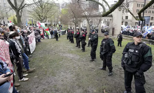 Police separate pro-Palestinian and pro-Israel demonstrators on the outskirts of a protest encampment on the grounds of McGill University, in Montreal, Thursday, May 2, 2024. (Ryan Remiorz/The Canadian Press via AP)