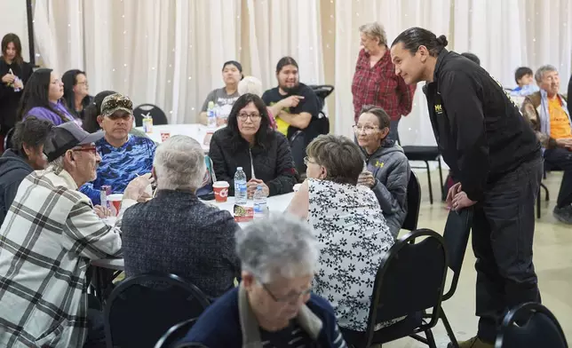 Manitoba Premier Wab Kinew speaks with evacuees from the Cranberry Portage area at the reception centre at the Wescana Inn in The Pas, Man., as wildfires burn in northern Manitoba, Tuesday, May 14, 2024. (David Lipnowski/The Canadian Press via AP)