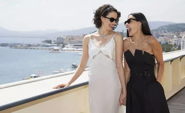 Margaret Qualley, left, and Demi Moore pose for photographers at the photo call for the film 'The Substance' at the 77th international film festival, Cannes, southern France, Sunday, May 19, 2024. (Photo by Scott A Garfitt/Invision/AP)