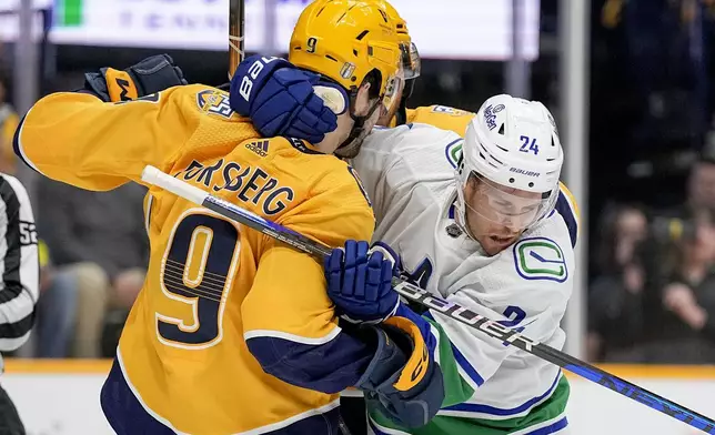 Nashville Predators left wing Filip Forsberg (9) and Vancouver Canucks center Pius Suter (24) get into a scuffle during the first period in Game 6 of an NHL hockey Stanley Cup first-round playoff series Friday, May 3, 2024, in Nashville, Tenn. (AP Photo/George Walker IV)