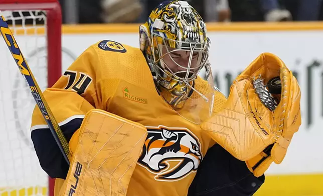 Nashville Predators goaltender Juuse Saros (74) catches a puck against the Vancouver Canucks during the third period in Game 6 of an NHL hockey Stanley Cup first-round playoff series Friday, May 3, 2024, in Nashville, Tenn. The Canucks won 1-0. (AP Photo/George Walker IV)