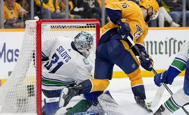 Vancouver Canucks goaltender Arturs Silovs (31) blocks a shot on goal by Nashville Predators left wing Jason Zucker (16) during the second period in Game 6 of an NHL hockey Stanley Cup first-round playoff series Friday, May 3, 2024, in Nashville, Tenn. (AP Photo/George Walker IV)