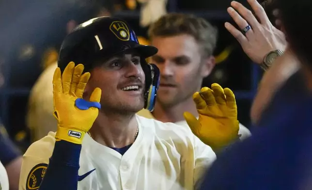 Milwaukee Brewers' Joey Ortiz is congrartulated after hitting a home run during the fourth inning of a baseball game against the St. Louis Cardinals Thursday, May 9, 2024, in Milwaukee. (AP Photo/Morry Gash)