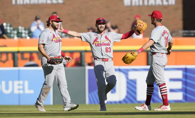 St. Louis Cardinals outfielders Alec Burleson, left, Michael Siani (63), and Lars Nootbaar celebrate the win by the Cardinals over the Detroit Tigers in the ninth inning in the first game of a baseball doubleheader, Tuesday, April 30, 2024, in Detroit. (AP Photo/Carlos Osorio)