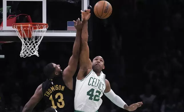 Boston Celtics center Al Horford (42) and Cleveland Cavaliers center Tristan Thompson (13) vie for a rebound during the first half of Game 1 of an NBA basketball second-round playoff series Tuesday, May 7, 2024, in Boston. (AP Photo/Charles Krupa)