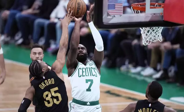 Boston Celtics guard Jaylen Brown (7) shoots against Cleveland Cavaliers forward Isaac Okoro (35) during the first half of Game 1 of an NBA basketball second-round playoff series Tuesday, May 7, 2024, in Boston. (AP Photo/Charles Krupa)