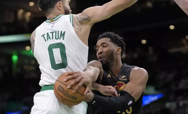 Cleveland Cavaliers guard Donovan Mitchell (45) tries to pass the ball around Boston Celtics forward Jayson Tatum (0) during the second half of Game 2 of an NBA basketball second-round playoff series Thursday, May 9, 2024, in Boston. (AP Photo/Steven Senne)