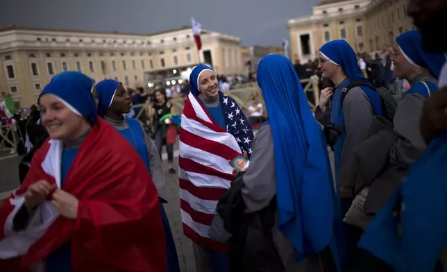 FILE - Nuns gather in St. Peter's Square at the Vatican, Saturday, April 26, 2014. Pilgrims and faithful gathered in Rome the day before Sunday's ceremony where Pope Francis elevated John XXIII and John Paul II to sainthood. (AP Photo/Emilio Morenatti, File)