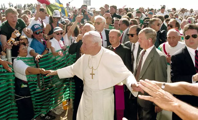 FILE - Pope John Paul II greets participants of World Youth Day as he arrives for Mass at Cherry Creek State Park in Aurora, Colo., Aug. 15, 1993. (AP Photo/Jeff Robbins, File)