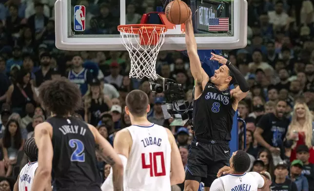 Dallas Mavericks guard Josh Green (8) slam dunks an alley oop from Mavericks' guard Luka Doncic, not pictured, over Los Angeles Clippers guard Norman Powell (24) as Clippers' center Ivica Zubac (40) and Mavericks' center Dereck Lively II (2) look on during the first half of Game 6 of an NBA basketball first-round playoff series Friday, May 3, 2024, in Dallas. (AP Photo/Jeffrey McWhorter)