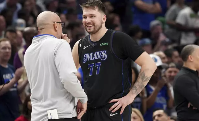 Dallas Mavericks guard Luka Doncic (77) talk with head coach Jason Kidd, left, during the first half of Game 6 of an NBA basketball first-round playoff series against the Los Angeles Clippers, Friday, May 3, 2024, in Dallas. (AP Photo/Jeffrey McWhorter)