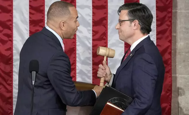 FILE - House Minority Leader Hakeem Jeffries of N.Y., hands the gavel to speaker-elect Rep. Mike Johnson, R-La., at the Capitol in Washington, Oct. 25, 2023. (AP Photo/Alex Brandon, File)