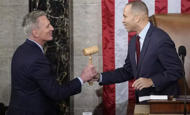 FILE - Incoming House Speaker Kevin McCarthy of Calif., receives the gavel from House Minority Leader Hakeem Jeffries of N.Y., on the House floor at the U.S. Capitol in Washington, early Saturday, Jan. 7, 2023. Republican McCarthy was elected House speaker on a historic post-midnight 15th ballot. (AP Photo/Andrew Harnik, File)