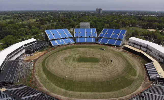 Work continues on a temporary stadium being constructed for the Cricket World Cup in East Meadow, N.Y., Wednesday, May 8, 2024. As the U.S. prepares to host its first Cricket World Cup across three states next month, a temporary stadium is rising in the NYC suburbs where the English sport has found fertile ground among waves of Caribbean and South Asian immigration. (AP Photo/Seth Wenig)