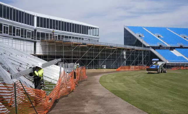 Work continues on a temporary stadium being constructed for the Cricket World Cup in East Meadow, N.Y., Wednesday, May 8, 2024. As the U.S. prepares to host its first Cricket World Cup across three states next month, a temporary stadium is rising in the NYC suburbs where the English sport has found fertile ground among waves of Caribbean and South Asian immigration. (AP Photo/Seth Wenig)