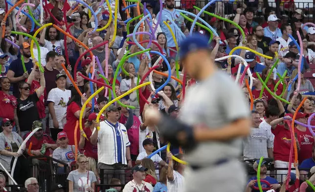 Fans shake balloons as Chicago Cubs starting pitcher Jameson Taillon steps to the mound during the sixth inning of a baseball game against the St. Louis Cardinals Saturday, May 25, 2024, in St. Louis. (AP Photo/Jeff Roberson)