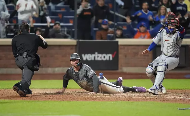 Chicago Cubs catcher Miguel Amaya celebrates as New York Mets' Pete Alonso, center, reacts after being called out at home plate on a fly out by Jeff McNeil to end the baseball game, Wednesday, May 1, 2024, in New York. The Cubs won 1-0. (AP Photo/Frank Franklin II)