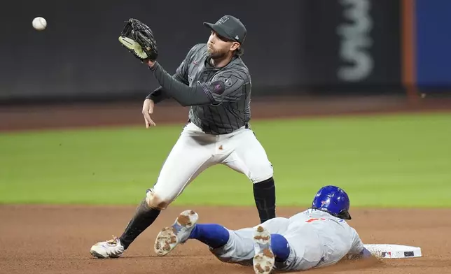 Chicago Cubs' Dansby Swanson (7) slides past New York Mets' Jeff McNeil (1) to steal second base during the seventh inning of a baseball game, Wednesday, May 1, 2024, in New York. (AP Photo/Frank Franklin II)