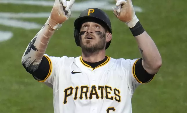 Pittsburgh Pirates' Yasmani Grandal celebrates as he crosses home plate after hitting a three-run home run off Chicago Cubs pitcher Keegan Thompson during the fifth inning of a baseball game in Pittsburgh, Saturday, May 11, 2024. (AP Photo/Gene J. Puskar)