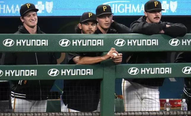 From left to right, Pittsburgh Pirates starting pitchers Quinn Priester, Jared Jones, Mitch Keller and Paul Skenes stand in the dugout during the seventh inning of a baseball game against the Chicago Cubs in Pittsburgh, Saturday, May 11, 2024. The game was Skenes' major league debut. (AP Photo/Gene J. Puskar)