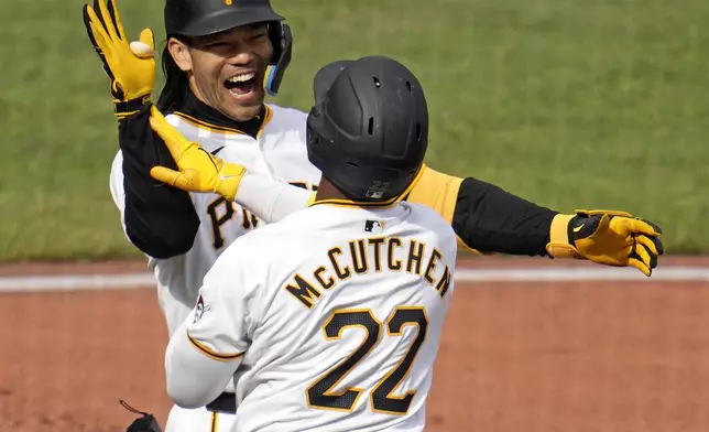 Pittsburgh Pirates' Connor Joe, left, celebrates with Andrew McCutchen (22) after hitting a three-run home run off Chicago Cubs starting pitcher Justin Steele during the third inning of a baseball game in Pittsburgh, Saturday, May 11, 2024. (AP Photo/Gene J. Puskar)