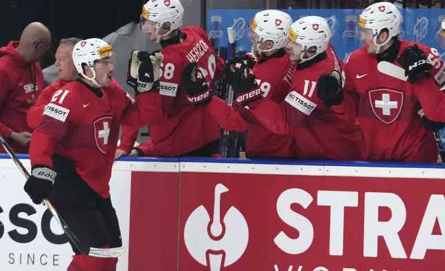 Switzerland's Kevin Fiala celebrates with teammates after scoring his sides first goal during the semifinal match between Canada and Switzerland at the Ice Hockey World Championships in Prague, Czech Republic, Saturday, May 25, 2024. (AP Photo/Petr David Josek)