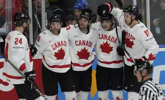 Canada's Brandon Tanev celebrates with teammates after scoring his side's opening goal during the semi final match between Canada and Switzerland at the Ice Hockey World Championships in Prague, Czech Republic, Saturday, May 25, 2024. (AP Photo/Darko Vojinovic)