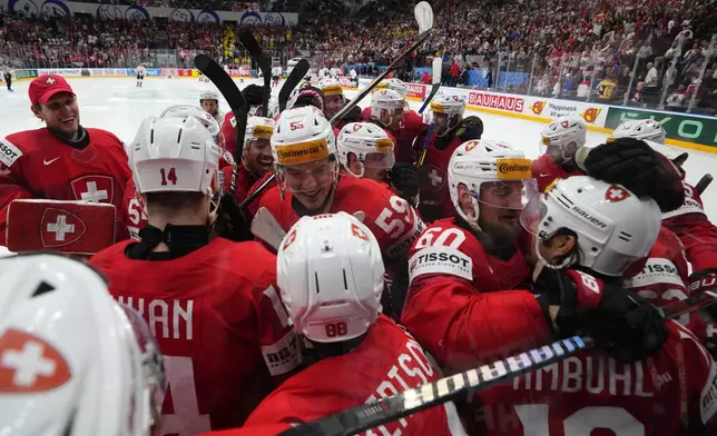Switzerland's players celebrate after the semifinal match between Canada and Switzerland at the Ice Hockey World Championships in Prague, Czech Republic, Saturday, May 25, 2024. (AP Photo/Petr David Josek)