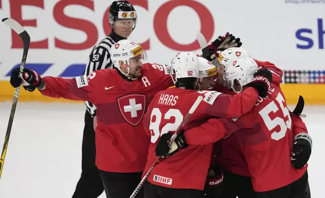 Switzerland's Kevin Fiala celebrates with teammates after scoring his side's opening goal during the semi final match between Canada and Switzerland at the Ice Hockey World Championships in Prague, Czech Republic, Saturday, May 25, 2024. (AP Photo/Darko Vojinovic)