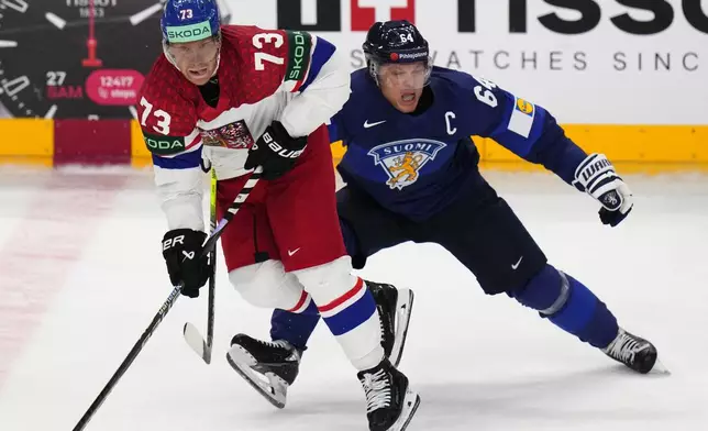 Finland's Mikael Granlund, right, challenges Czech Republic's Ondrej Kase during the preliminary round match between Czech Republic and Finland at the Ice Hockey World Championships in Prague, Czech Republic, Friday, May 10, 2024. (AP Photo/Petr David Josek)