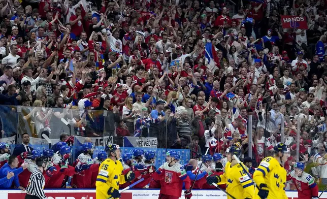 Czech Republic's Martin Necas, center, celebrates with fans and teammates after scoring his sides fourth goal during the semifinal match between Czech Republic and Sweden at the Ice Hockey World Championships in Prague, Czech Republic, Saturday, May 25, 2024. (AP Photo/Petr David Josek)