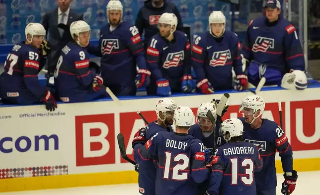 Unted States' Zach Werenski celebrates with teammates after scoring his side's opening goal during the preliminary round match between Sweden and United States at the Ice Hockey World Championships in Ostrava, Czech Republic, Friday, May 10, 2024. (AP Photo/Darko Vojinovic)