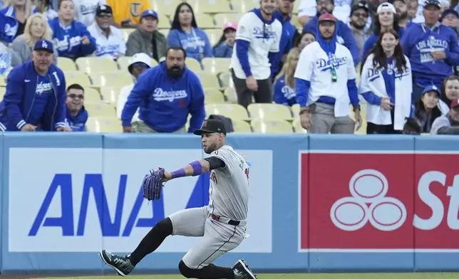 Arizona Diamondbacks left fielder Lourdes Gurriel Jr. makes a sliding catch on a fly ball hit by Los Angeles Dodgers' Mookie Betts during the first inning of a baseball game Monday, May 20, 2024, in Los Angeles. (AP Photo/Marcio Jose Sanchez)