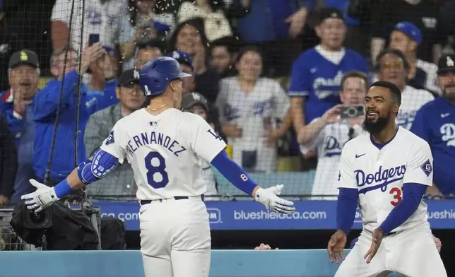 Los Angeles Dodgers' Kiké Hernández, left, celebrates after his solo home run with Teoscar Hernández during the third inning of a baseball game against the Arizona Diamondbacks, Monday, May 20, 2024, in Los Angeles. (AP Photo/Marcio Jose Sanchez)