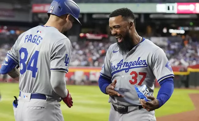Los Angeles Dodgers' Andy Pages (84) celebrates his two-run home run against the Arizona Diamondbacks with Dodgers' Teoscar Hernández (37) during the second inning of a baseball game Wednesday, May 1, 2024, in Phoenix. (AP Photo/Ross D. Franklin)