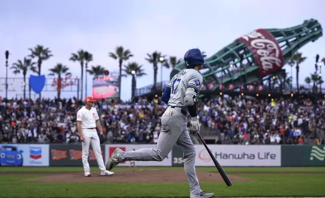Los Angeles Dodgers' Shohei Ohtani, right, runs the bases after hitting a solo home run against San Francisco Giants pitcher Keaton Winn, background, during the fourth inning of a baseball game Tuesday, May 14, 2024, in San Francisco. (AP Photo/Godofredo A. Vásquez)