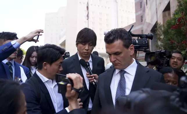 Ippei Mizuhara, center, the former longtime interpreter for the Los Angeles Dodgers baseball star Shohei Ohtani, leaves federal court following his arraignment, Tuesday, May 14, 2024, in Los Angeles. Mizuhara pleaded not guilty Tuesday to bank and tax fraud, a formality ahead of a plea deal he’s negotiated with federal prosecutors in a wide-ranging sports betting case. (AP Photo/Eric Thayer)