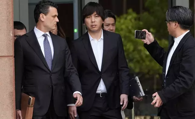 Ippei Mizuhara, center, the former longtime interpreter for the Los Angeles Dodgers baseball star Shohei Ohtani, leaves federal court following his arraignment, Tuesday, May 14, 2024, in Los Angeles. Mizuhara pleaded not guilty Tuesday to bank and tax fraud, a formality ahead of a plea deal he’s negotiated with federal prosecutors in a wide-ranging sports betting case. (AP Photo/Damian Dovarganes)