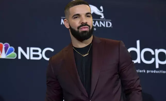 FILE - Drake poses at the Billboard Music Awards in Las Vegas on May 1, 2019. Police are investigating a shooting outside rapper Drake’s mansion that left a security guard seriously wounded. Authorities did not confirm whether Drake was at home at the time of the shooting, but said his team is cooperating. The shooting happened around 2 a.m. Tuesday in the affluent Bridle Path neighborhood of Toronto. (Photo by Richard Shotwell/Invision/AP, File)