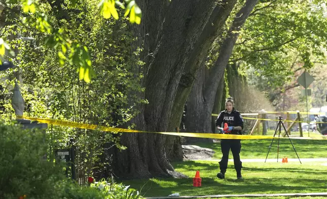 Toronto Police investigate a shooting outside the mansion of rapper Drake in Toronto's Bridle Path neighborhood, Tuesday, May 7, 2024. Paramedics said a security guard working outside the home was taken to hospital with serious but non-life-threatening injuries in an overnight shooting. (Nathan Denette/The Canadian Press via AP)