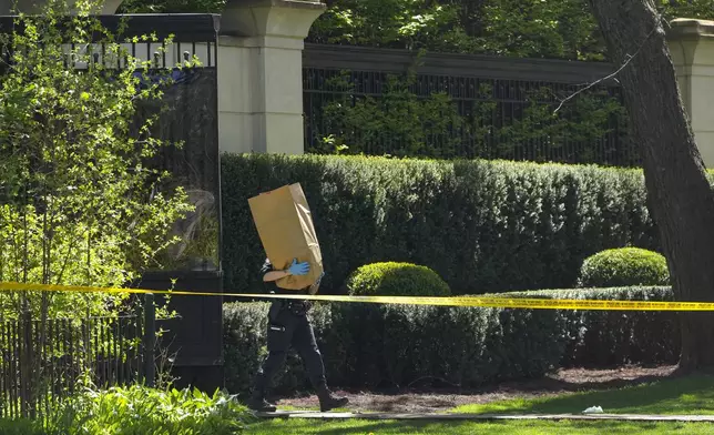 Toronto Police investigate a shooting outside the mansion of rapper Drake in Toronto's Bridle Path neighborhood, Tuesday, May 7, 2024. Paramedics said a security guard working outside the home was taken to hospital with serious but non-life-threatening injuries in an overnight shooting. (Nathan Denette/The Canadian Press via AP)