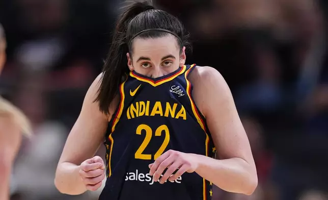 Indiana Fever guard Caitlin Clark wipes her face after hitting a shot and being fouled by the Atlanta Dream during the first half of a preseason WNBA basketball game in Indianapolis, Thursday, May 9, 2024. (AP Photo/Darron Cummings)