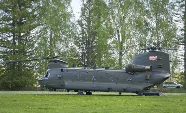 A British Chinook helicopter waits to take senior Estonian officials back to the capital of Tallinn after they watched military exercises in an undisclosed part of Estonia, Wednesday, May 15, 2024. Estonian, British and French forces took part in the exercises which were dubbed Spring Storm. (AP Photo/Hendrik Osula)