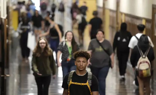 Students mix in a hallway as they change classes at Topeka High School Friday, May 10, 2024, in Topeka, Kan. Schools in the city were at the center of a case that struck down segregated education. Only the district's grade schools were segregated at the time of the ruling. (AP Photo/Charlie Riedel)