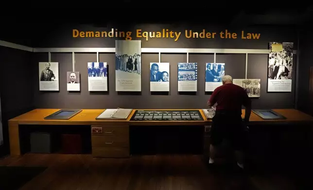 A man views an exhibit in the former Monroe school, which now houses a national historic site, Friday, May 10, 2024, in Topeka, Kan. The school was at the center of the Brown v. Board of Education Supreme Court ruling ending segregation in public schools 70 years ago. (AP Photo/Charlie Riedel)