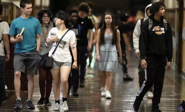 Students mix in a hallway as they change classes at Topeka High school Friday, May 10, 2024, in Topeka, Kan. Topeka is the home of the former Monroe school which was at the center of the Brown v. Board of Education Supreme Court ruling ending segregation in public schools 70 years ago. (AP Photo/Charlie Riedel)